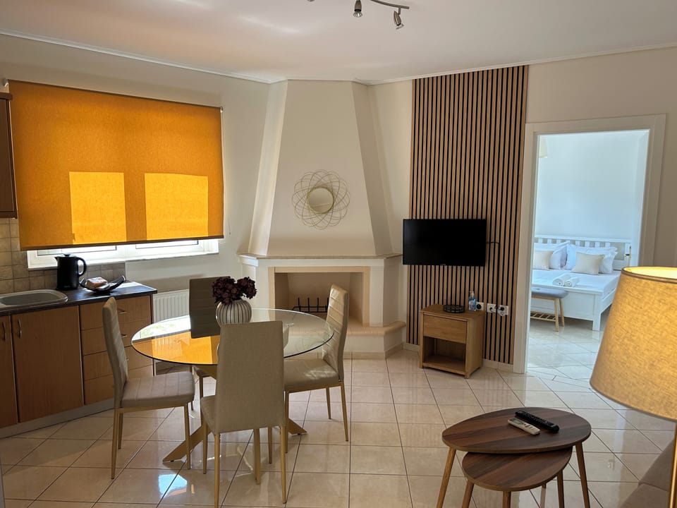 Comfort Apartment, City View | Living area | 32-inch flat-screen TV with digital channels, fireplace