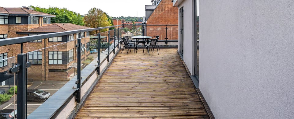 OVER-HANGING BALCONY WITH TABLE AND CHAIRS