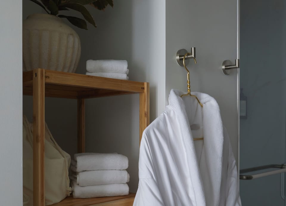 Shower, designer toiletries, hair dryer, towels