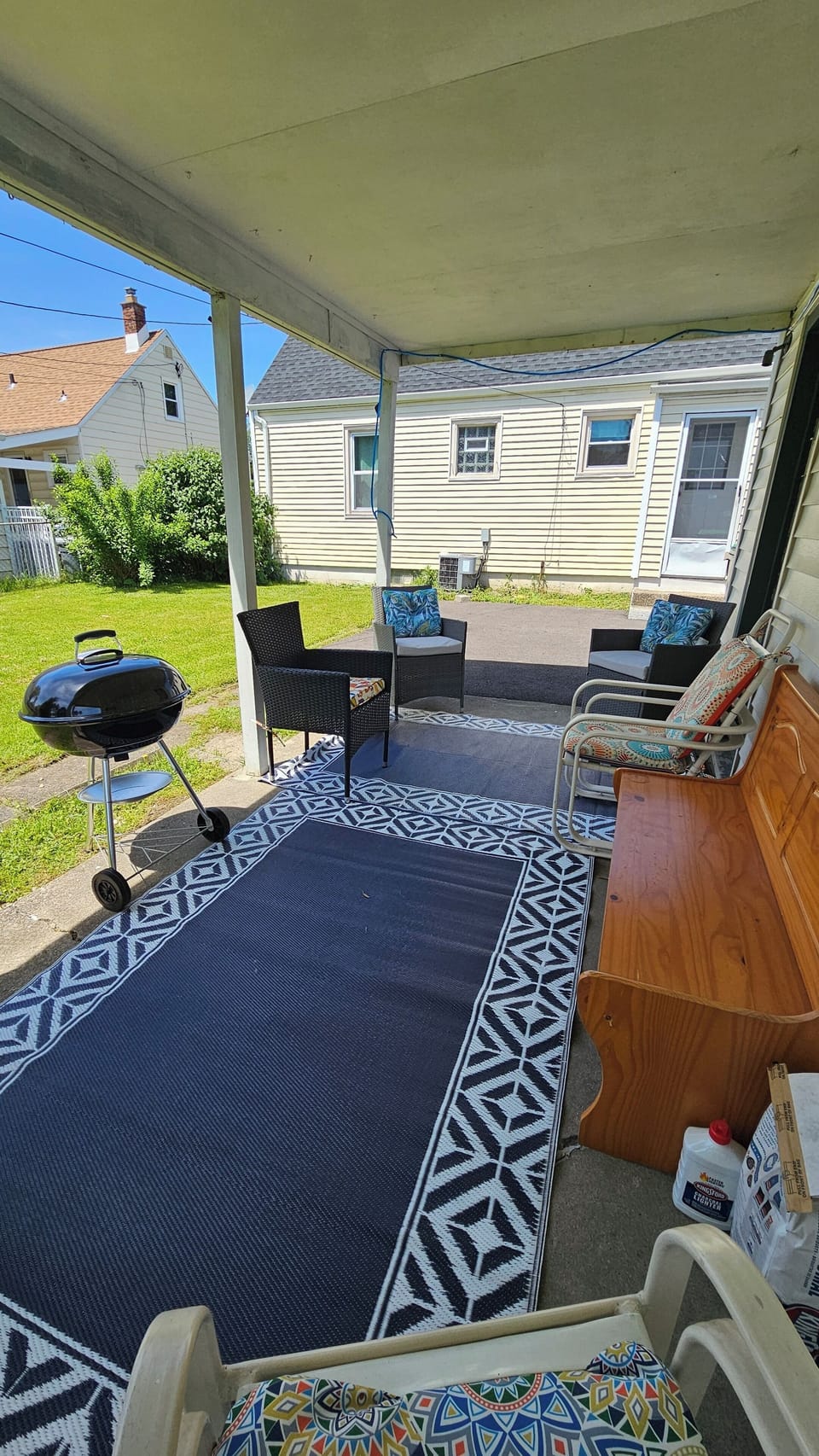 back porch with patio chairs n grill