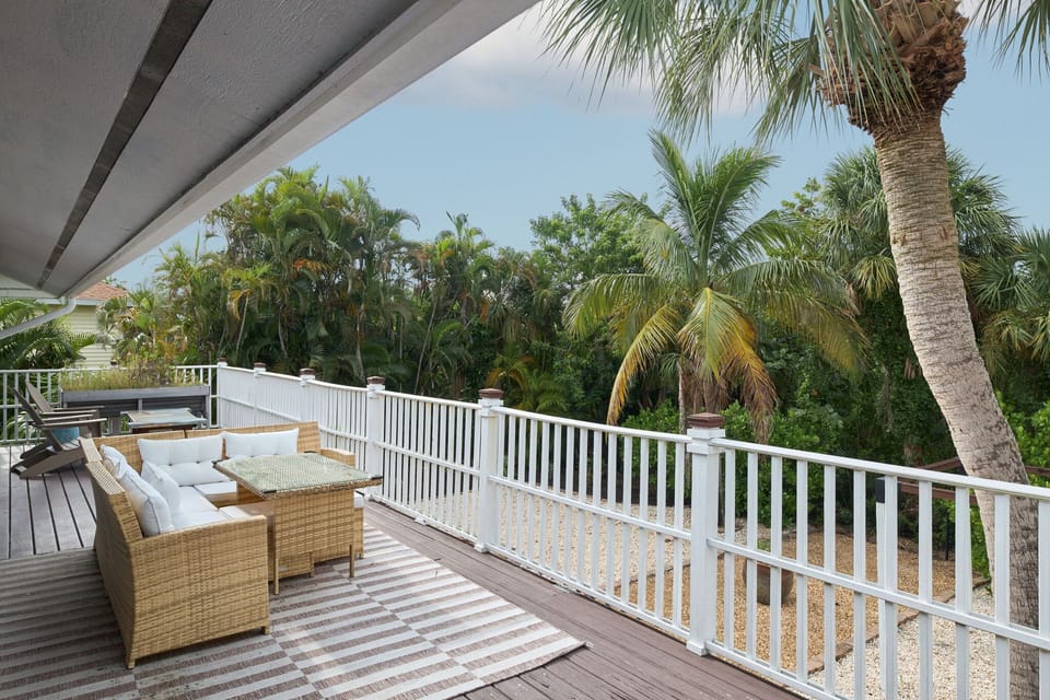 Patio with ample furniture overlooking peaceful and serene gardens