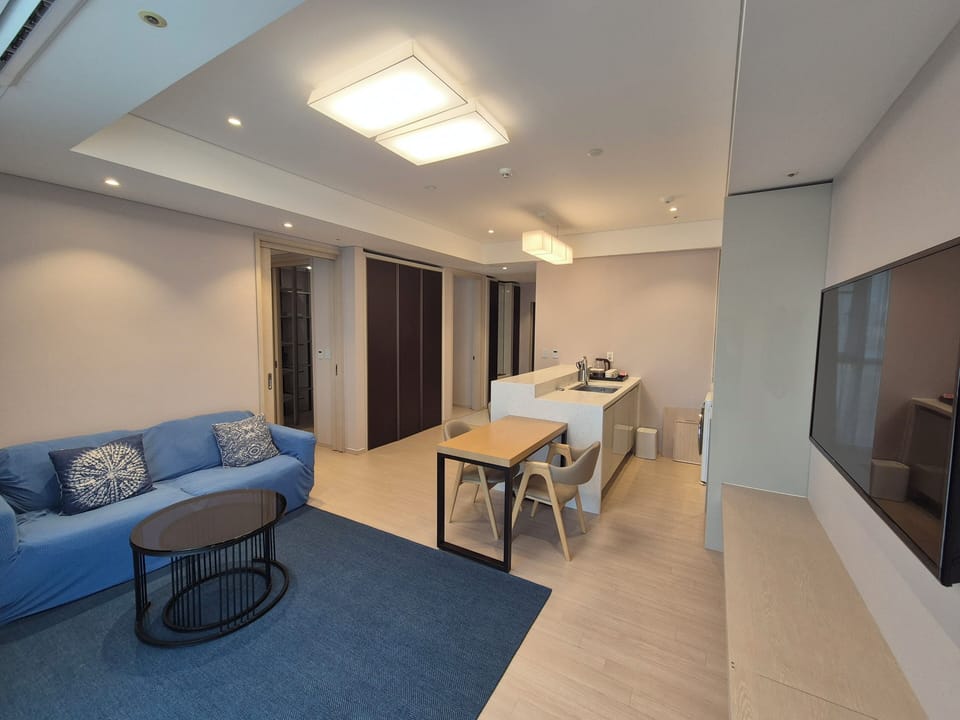 Residence connecting suite room | Living area | 96-cm TV with cable channels, printers