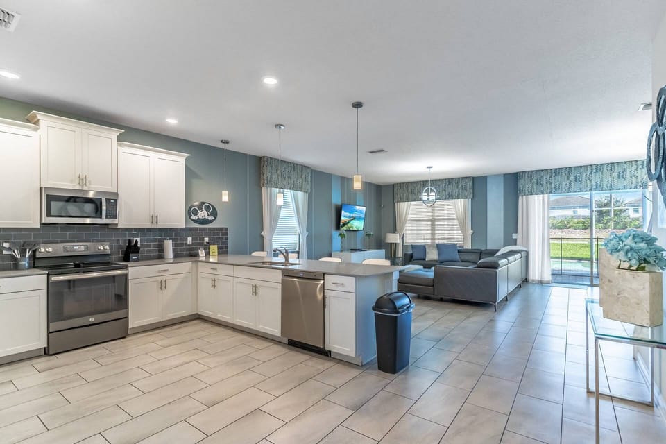 Open Floorpan with modern kitchen: granite counter tops, stainless steel appliances, and access to the living room and private pool!