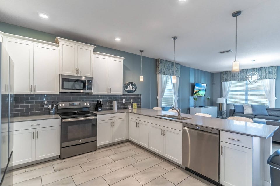 Open Floorpan with modern kitchen: granite counter tops, stainless steel appliances, and access to the living room and private pool!