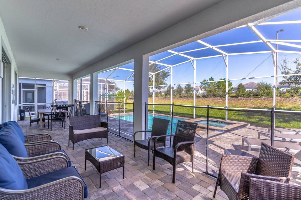 Spacious covered lanai with dining and lounge seating (Grill shown for onwer use ONLY. Please inquire about renting a grill for your stay)