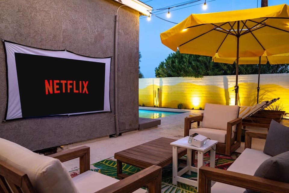 Unwind with a movie night under the stars in this cozy outdoor lounge.