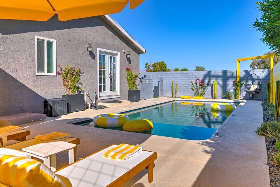 Soak up the sun by the poolside patio with comfy loungers and vibrant decor (Floaties not provided in the property)