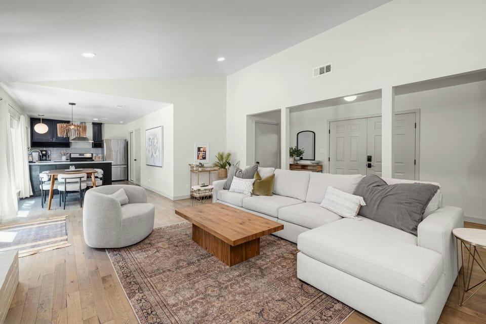 An open-concept floor plan for entertaining seamlessly connects the kitchen, dining, and living areas, creating a spacious environment that allows you and your guests to interact and move freely while enjoying a cohesive and inviting atmosphere.