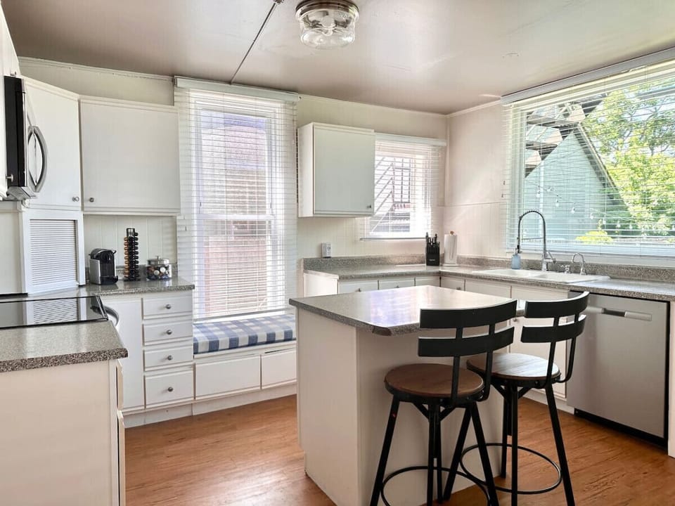 Our spacious kitchen featuring a stylish center island and cozy stools is perfect for family gatherings