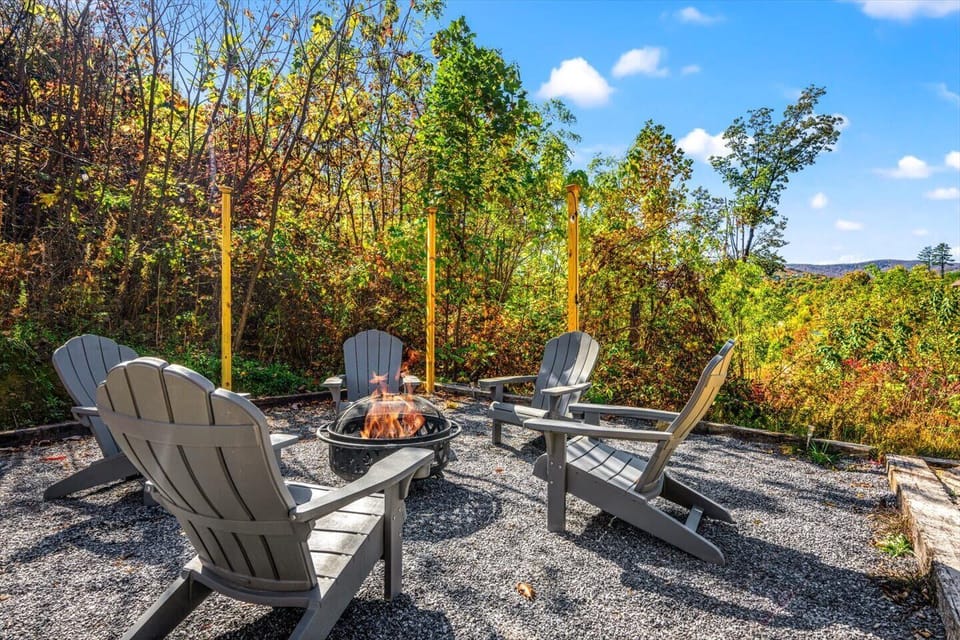 Cozy outdoor fire pit area with chairs, perfect for relaxing under the stars. Enjoy peaceful mountain views, crisp evening air, and unforgettable moments with family and friends in this serene Smoky Mountain retreat!