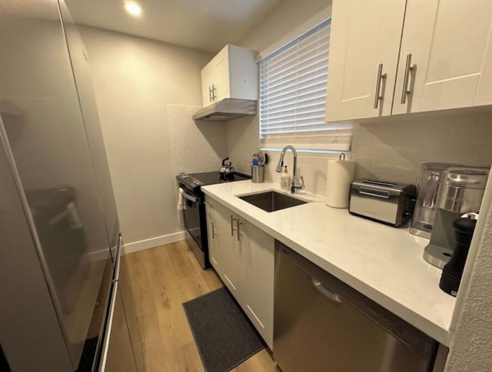 Full kitchen with fridge, stove and dishwasher.