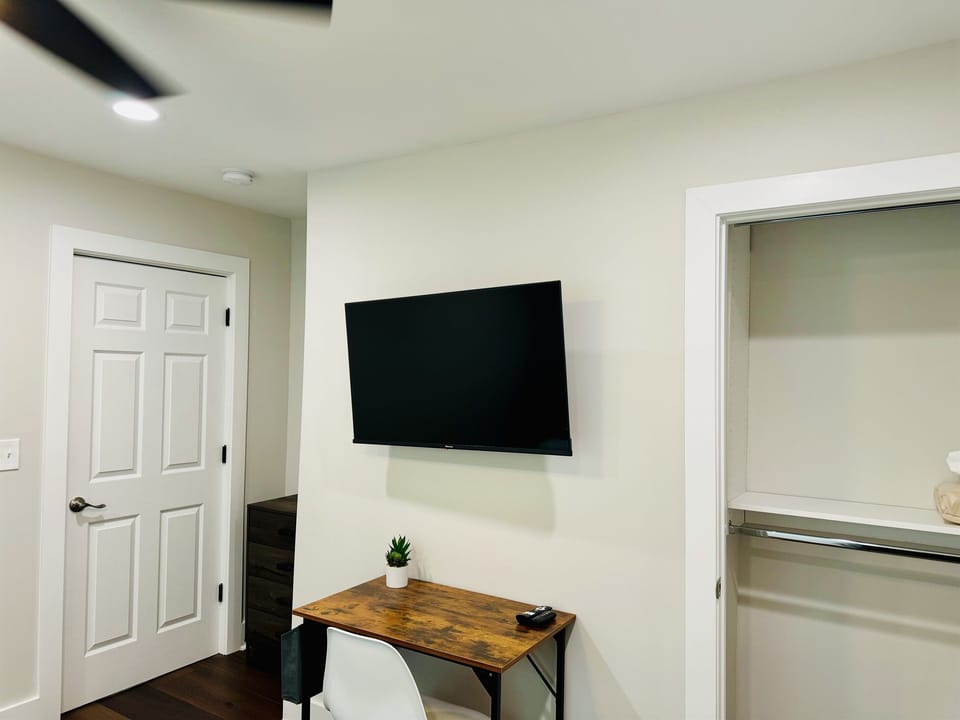 Bedroom 2 with Nectar King bed mattress, closet space, 43 in Smart TV and desk/desk chair.