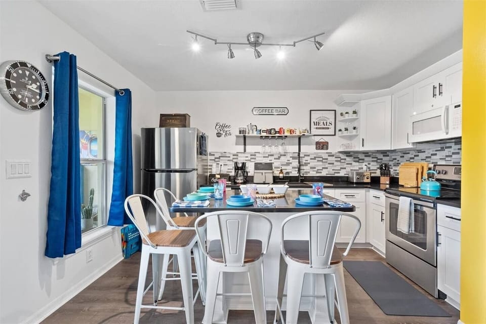 Full kitchen with high chair and toddler/baby plates.