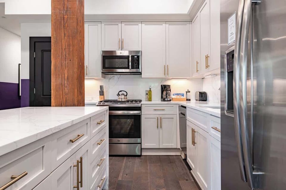 Cook or snack in style with a full kitchen featuring GE stainless appliances, cookware, and an island with bar seating. Ideal for short or extended stays, our kitchens make group travel in New Orleans easy and comfortable.