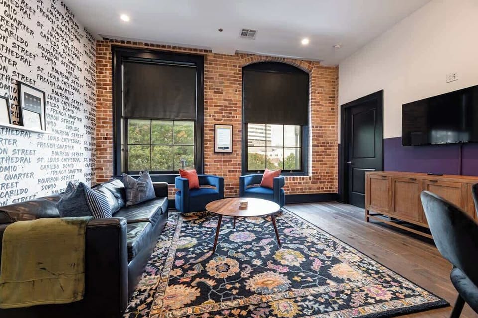 Relax in the living area with a smart TV, stylish seating, and a sleeper sofa for extra guests. Perfect for families or group stays in New Orleans, this inviting space is ideal for movie nights or recharging after a day in the city.