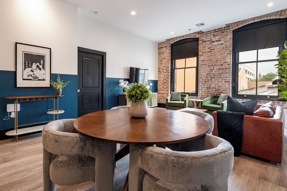 Enjoy meals together at your in-suite dining table with seating for your group. Whether it's takeout, delivery, or a home-cooked meal, this cozy dining area makes every stay at 888 Baronne feel like home in New Orleans.