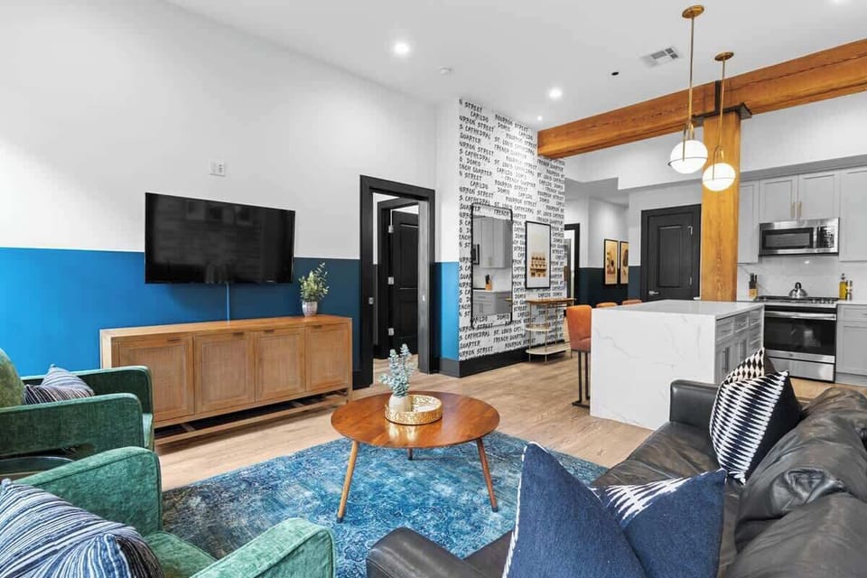 Relax in the living area with a smart TV, stylish seating, and a sleeper sofa for extra guests. Perfect for families or group stays in New Orleans, this inviting space is ideal for movie nights or recharging after a day in the city.