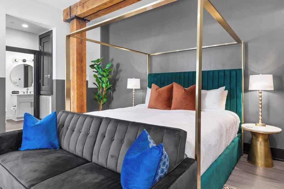 Retreat to the sleeping area with a plush king bed, blackout shades, and a smart TV.