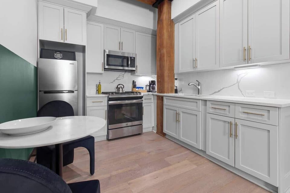 Cook or snack in style with a full kitchen featuring GE stainless appliances, cookware, and an island with bar seating. Ideal for short or extended stays, our kitchens make group travel in New Orleans easy and comfortable.