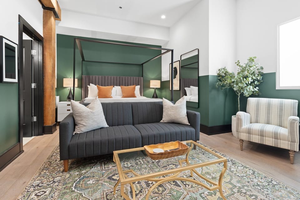 Relax in the studio living area with a smart TV, stylish seating, king-sized bed and a futon for extra guest. This inviting space is ideal for movie nights or recharging after a day in the city.