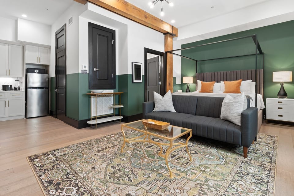 Relax in the studio living area with a smart TV, stylish seating, king-sized bed and a futon for extra guest. This inviting space is ideal for movie nights or recharging after a day in the city.