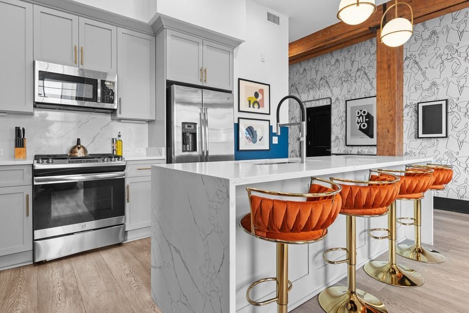 Cook or snack in style with a full kitchen featuring GE stainless appliances, cookware, and an island with bar seating. Ideal for short or extended stays, our kitchens make group travel in New Orleans easy and comfortable.