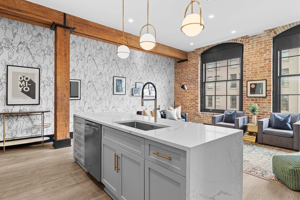 Cook or snack in style with a full kitchen featuring GE stainless appliances, cookware, and an island with bar seating. Ideal for short or extended stays, our kitchens make group travel in New Orleans easy and comfortable.