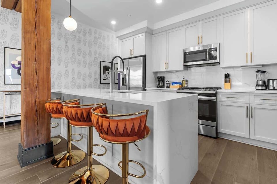 Cook or snack in style with a full kitchen featuring GE stainless appliances, cookware, and an island with bar seating. Ideal for short or extended stays, our kitchens make group travel in New Orleans easy and comfortable.