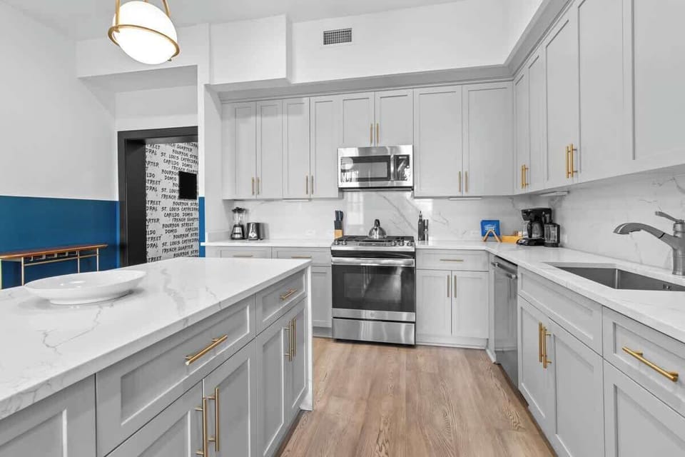 Cook or snack in style with a full kitchen featuring GE stainless appliances, cookware, and an island with bar seating. Ideal for short or extended stays, our kitchens make group travel in New Orleans easy and comfortable.