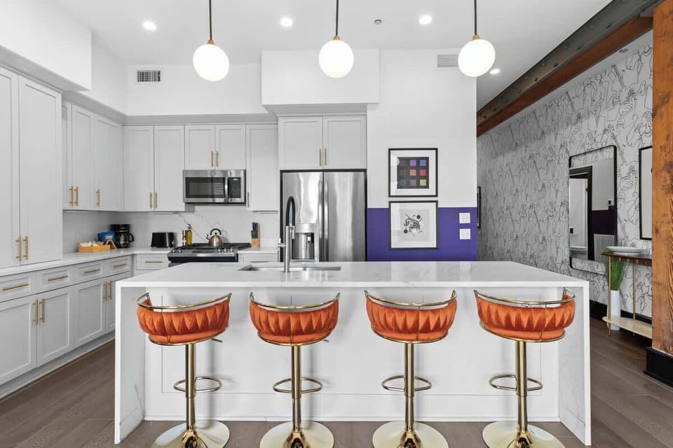 Cook or snack in style with a full kitchen featuring GE stainless appliances, cookware, and an island with bar seating. Ideal for short or extended stays, our kitchens make group travel in New Orleans easy and comfortable.