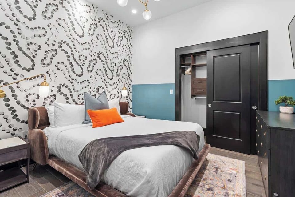 The second bedroom offers a cozy queen bed, dresser, smart TV, and soft linens. Great for families or friends traveling together, this room combines comfort and privacy in the heart of Downtown New Orleans.