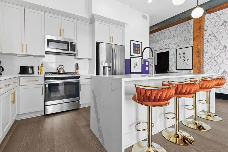 Cook or snack in style with a full kitchen featuring GE stainless appliances, cookware, and an island with bar seating. Ideal for short or extended stays, our kitchens make group travel in New Orleans easy and comfortable.
