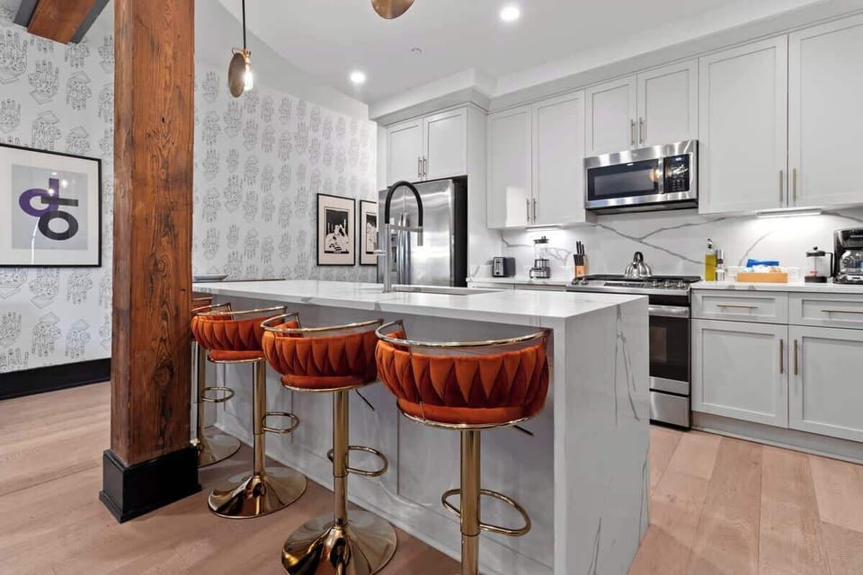 Cook or snack in style with a full kitchen featuring GE stainless appliances, cookware, and an island with bar seating. Ideal for short or extended stays, our kitchens make group travel in New Orleans easy and comfortable.