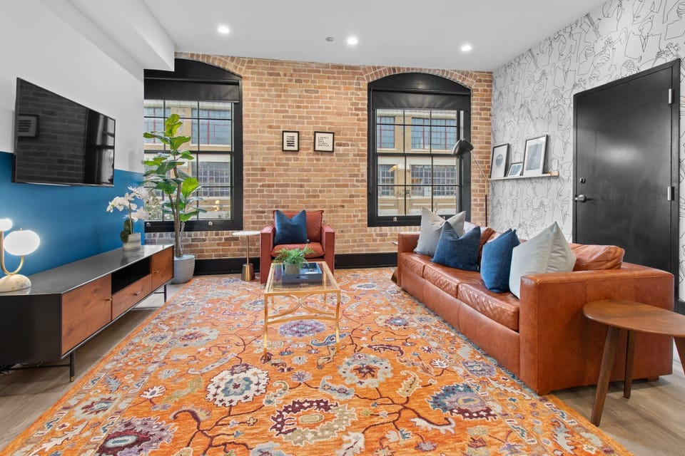 Relax in the living area with a smart TV, stylish seating, and a sleeper sofa for extra guests. Perfect for families or group stays in New Orleans, this inviting space is ideal for movie nights or recharging after a day in the city.