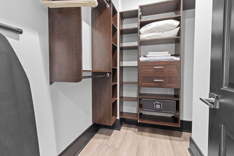 The primary bathroom offers sleek finishes, a soaking tub with Smart TV, walk-in shower, and plush towels. Spacious and private, it adds a luxurious touch to your suite—perfect for unwinding after a day in Downtown New Orleans.