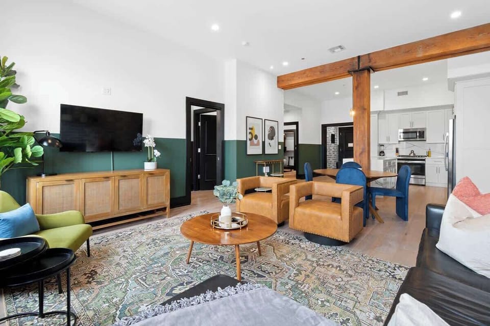 Relax in the living area with a smart TV, stylish seating, and a sleeper sofa for extra guests. Perfect for families or group stays in New Orleans, this inviting space is ideal for movie nights or recharging after a day in the city.