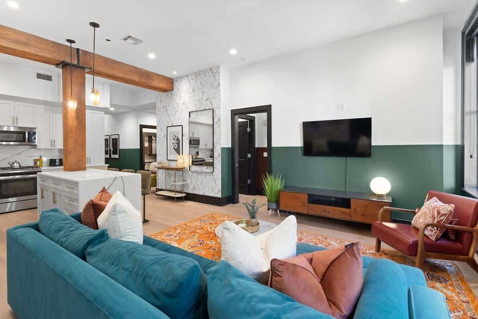 Relax in the living area with a smart TV, stylish seating, and a queen-sized sleeper sofa for extra guests. Perfect for families or group stays in New Orleans, this inviting space is ideal for movie nights or recharging after a day in the city.