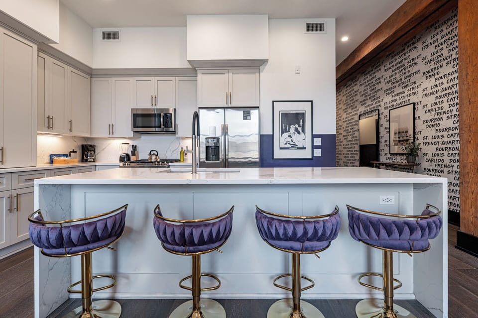 Cook or snack in style with a full kitchen featuring GE stainless appliances, cookware, and an island with bar seating. Ideal for short or extended stays, our kitchens make group travel in New Orleans easy and comfortable.