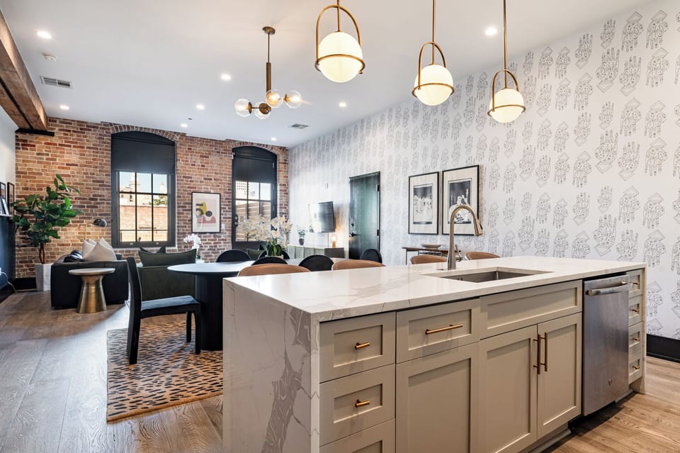 Cook or snack in style with a full kitchen featuring GE stainless appliances, cookware, and an island with bar seating. Ideal for short or extended stays, our kitchens make group travel in New Orleans easy and comfortable.