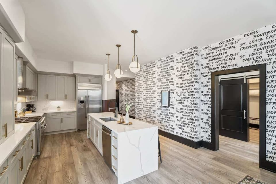 Cook or snack in style with a full kitchen featuring GE stainless appliances, cookware, and an island with bar seating. Ideal for short or extended stays, our kitchens make group travel in New Orleans easy and comfortable.