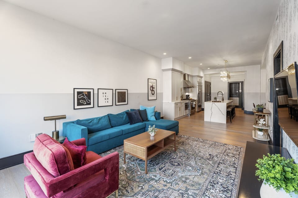 Relax in the living area with a smart TV, stylish seating, and a sleeper sofa for extra guests. Perfect for families or group stays in New Orleans, this inviting space is ideal for movie nights or recharging after a day in the city.
