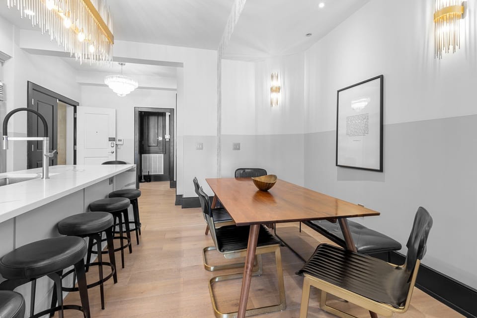 Enjoy meals together at your in-suite dining table with seating for your group. Whether it's takeout, delivery, or a home-cooked meal, this cozy dining area makes every stay at 888 Baronne feel like home in New Orleans.