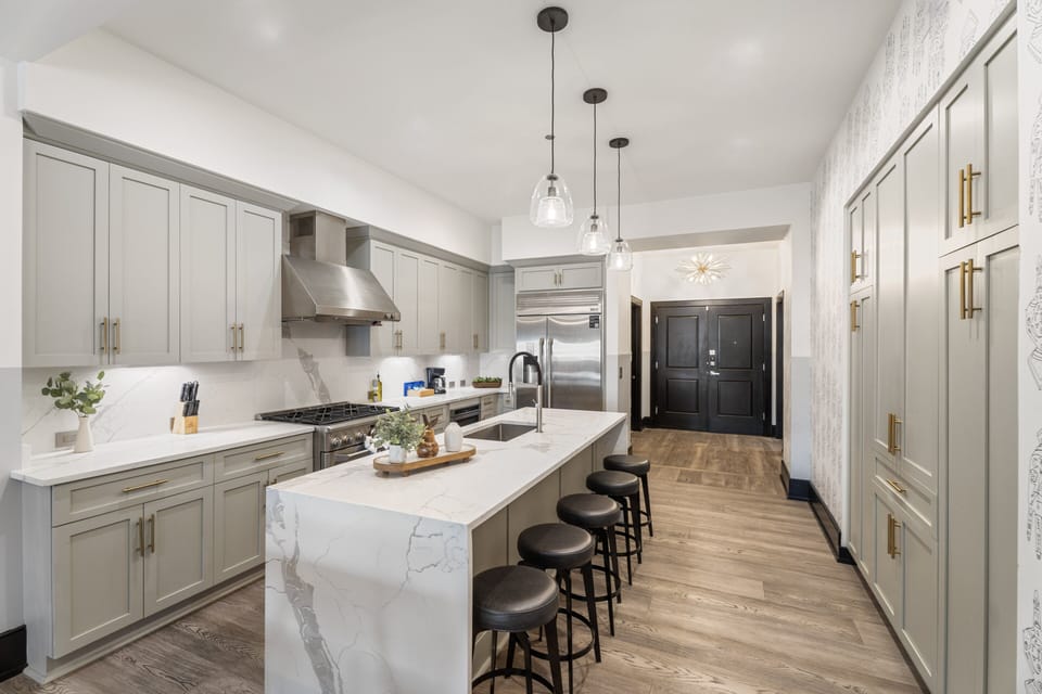 Cook or snack in style with a full kitchen featuring GE stainless appliances, cookware, and an island with bar seating. Ideal for short or extended stays, our kitchens make group travel in New Orleans easy and comfortable.