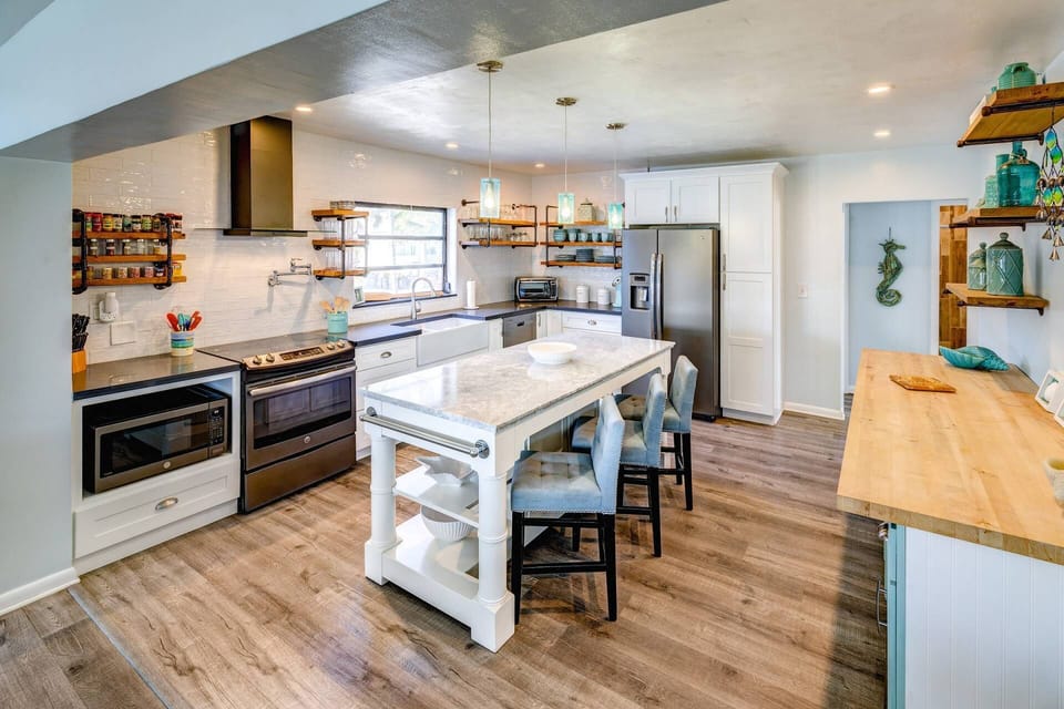 The updated, spacious kitchen boasts modern appliances, ample counter space, and a sleek design perfect for cooking and entertaining.