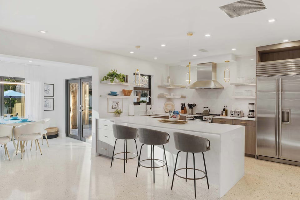 With top-of-the-line appliances and a large island for prepping and gathering, this fully stocked kitchen is as practical as it is luxurious.
