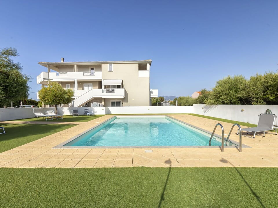 Sky, Water, Property, Plant, Building, Swimming Pool, Tree, Azure, Rectangle, Grass