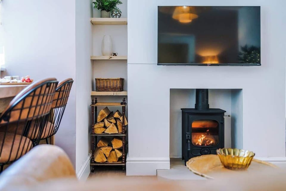 Fully furnished living area featuring a beautiful wood-burning fireplace.