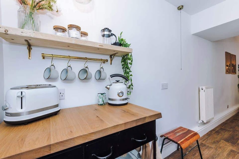 Fully equipped kitchen. Stylish, modern space featuring a farmhouse sink, wooden countertops, and all the essentials for your stay.
