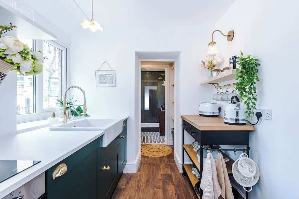Fully equipped kitchen. Stylish, modern space featuring a farmhouse sink, wooden countertops, and all the essentials for your stay.
