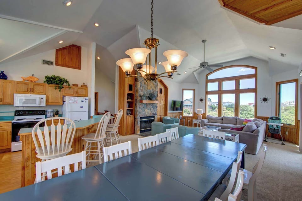 Expanded dining area seating 12 with a 4-person breakfast bar connected to the kitchen